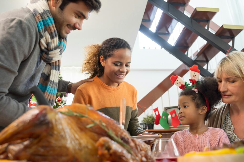 Family celebrating thanksgiving day dinner at home.