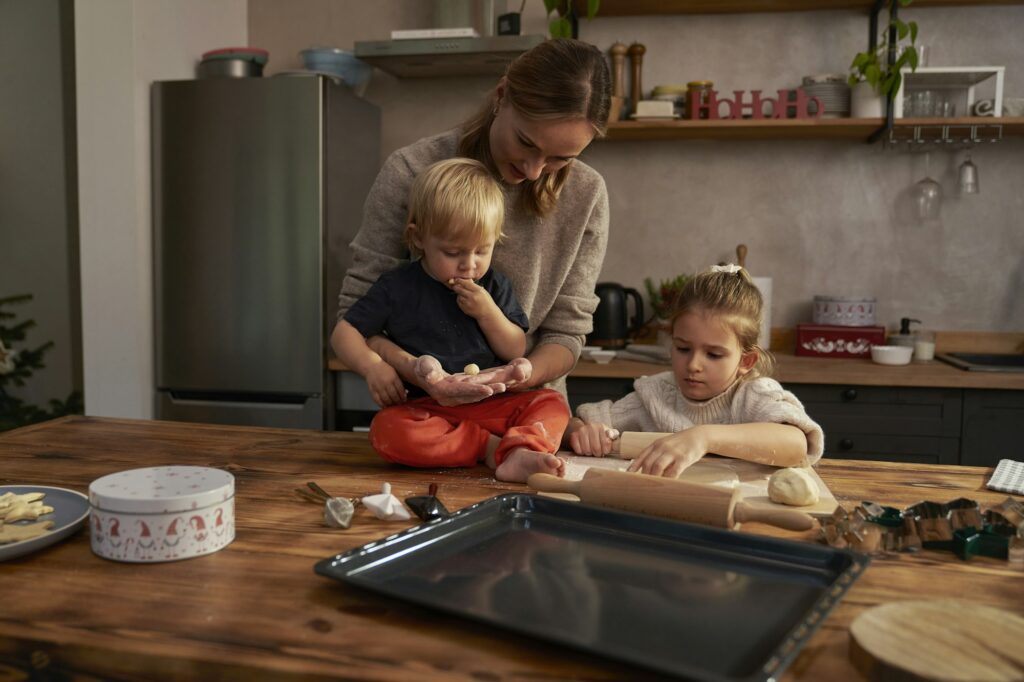 Woman and her children baking Christmas cookies
