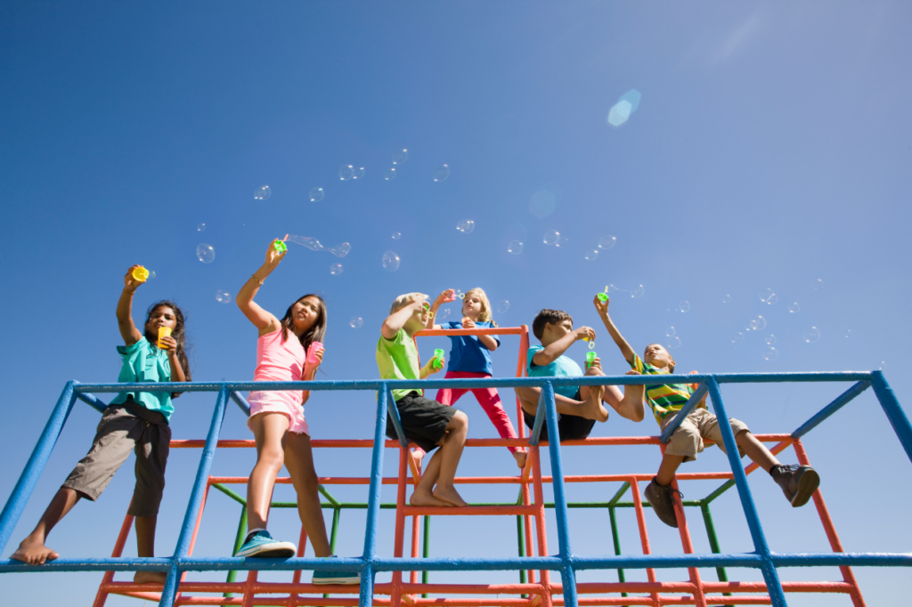 wide-shot-of-children-sitting-on-monkey-bars-and-b-2026-01-11-09-52-50-utc